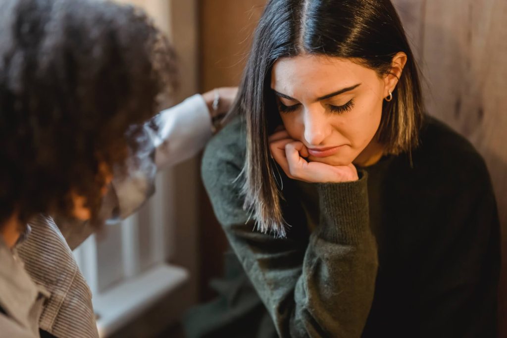 A girl comforting her sad friend with empathy and compassion